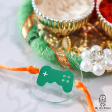 Load image into Gallery viewer, Close-up of gaming controller rakhi charm with custom name detail
