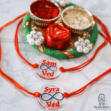 Load image into Gallery viewer, Close-up of engraved wood infinity rakhi with custom names